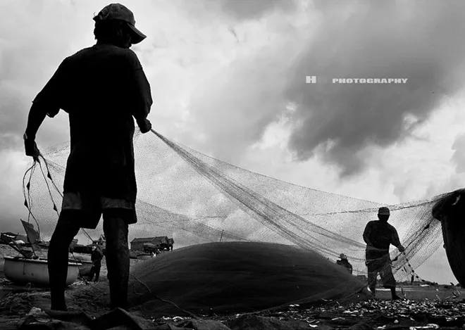 Người dân làng chài đang kéo lưới lên bờ.